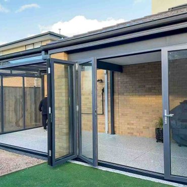 Modern backyard room with sliding glass walls