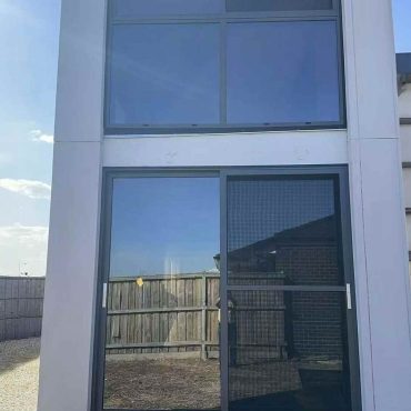 Modern home with large windows and sliding door