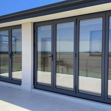 Modern house with black framed sliding doors