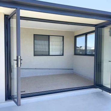 Modern outdoor room with open sliding doors