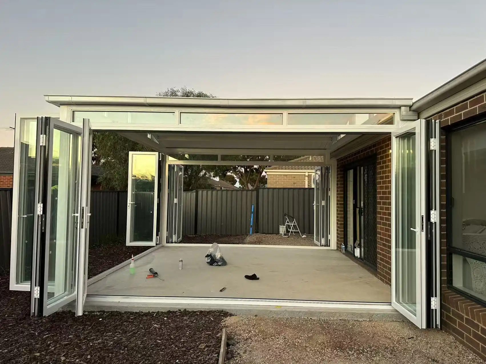 Glass sunroom on site with installation tools still in the room