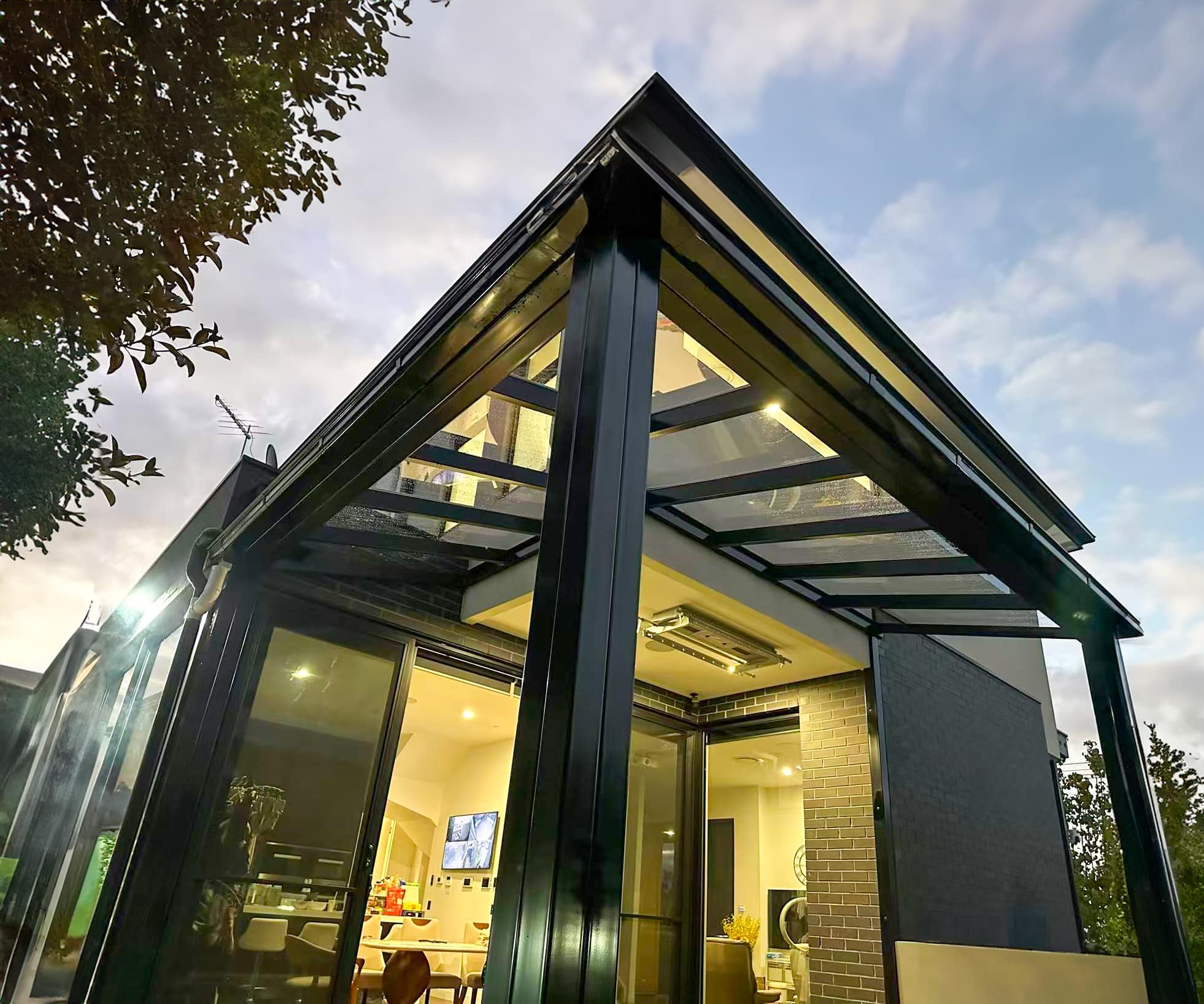 Installer building the aluminium frame of a glass sunroom structure