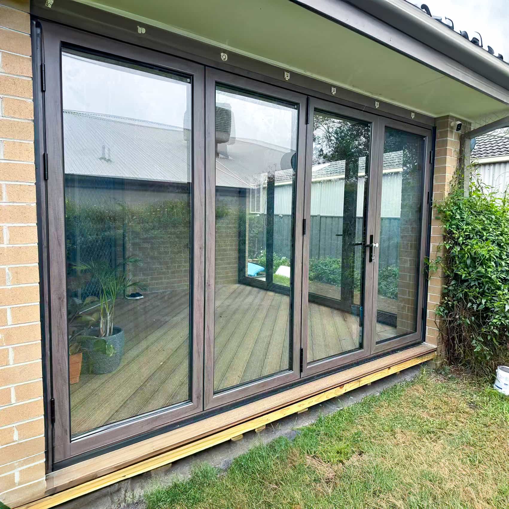 Installer fitting a large-format sliding glass door panel